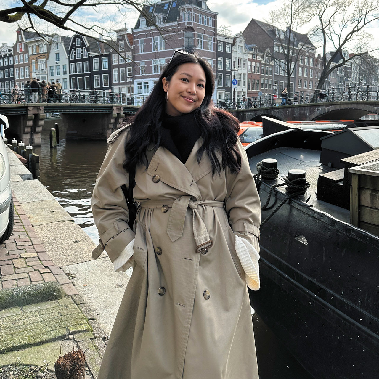 The writer in a trench coat by a canal