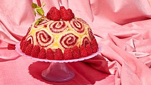 A lemon blast bombe cake topped with fresh raspberries