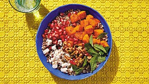 Roasted squash and quinoa salad served on a blue plate