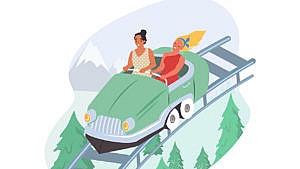 Two women in a roller coaster car heading down a ramp