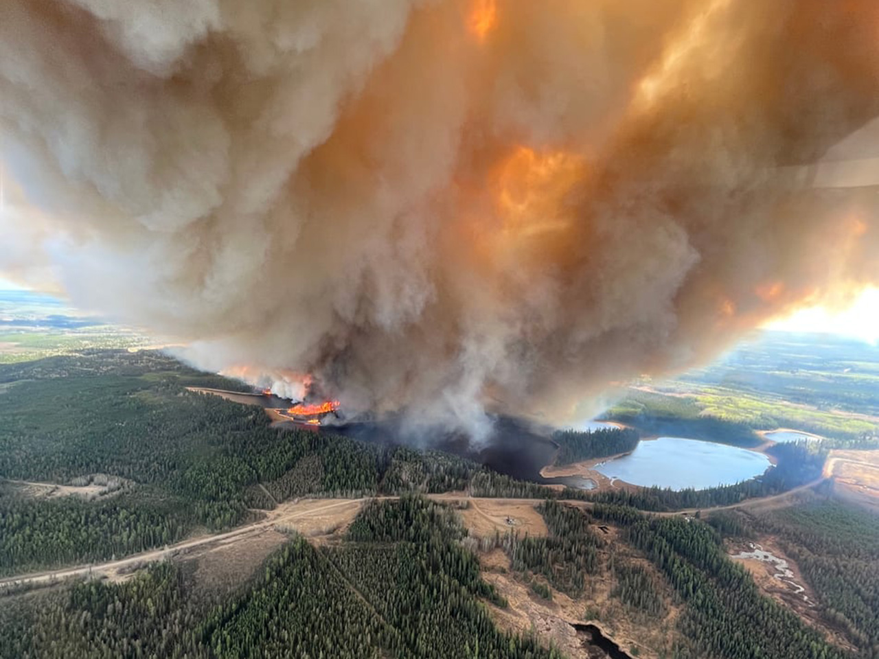 Smoke from an out-of-control fire near Lodgepole, Alta. An out-of-control wildfire has caused thousands of people to flee their homes in Drayton Valley, Alta., and the surrounding rural area. 