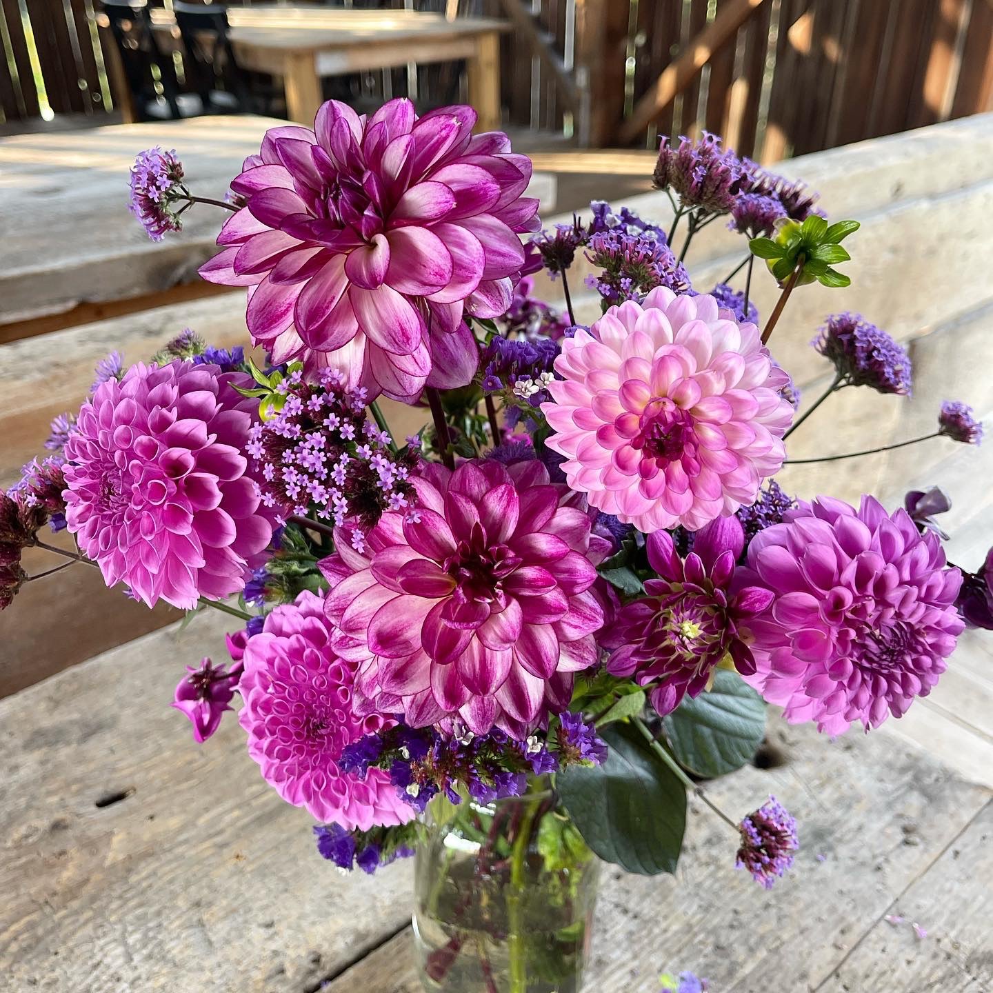 A bouquet of purple blooms against a barn wall 