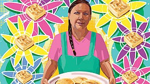 A woman in a t-shirt with an apron overtop and a single long brain over her left shoulder holds a platter of freshly made bannock