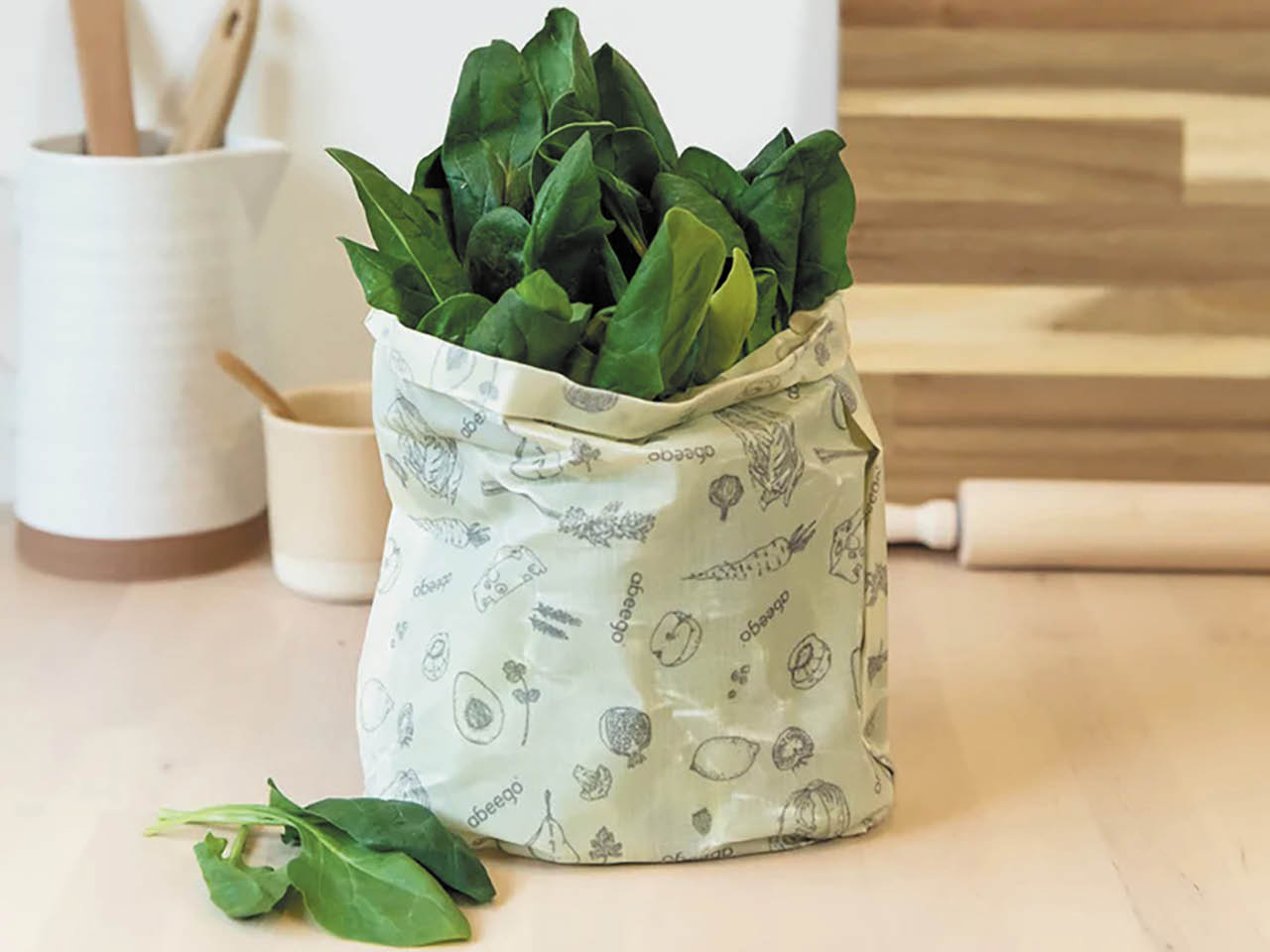 An abeego beeswax wrap wrapped around a bundle of lettuce