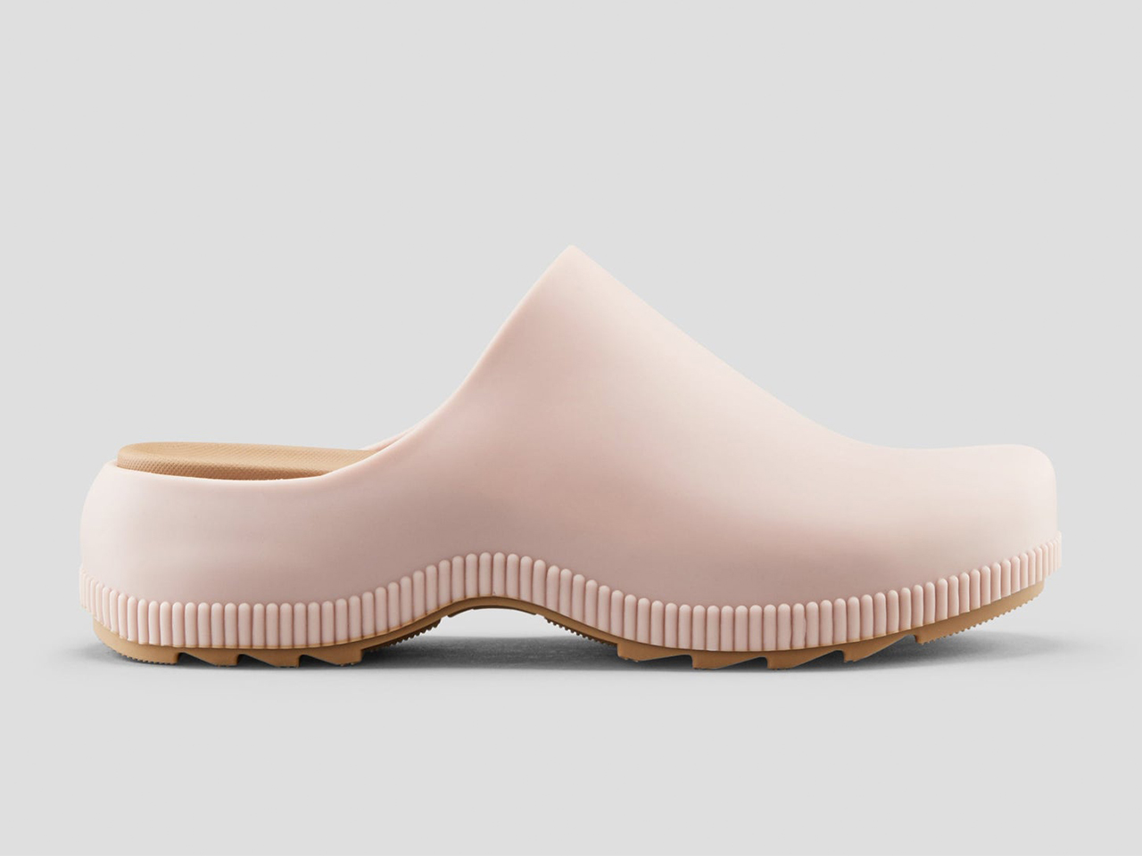 A side profile of a pair of pink water-friendly clogs from Cougar.