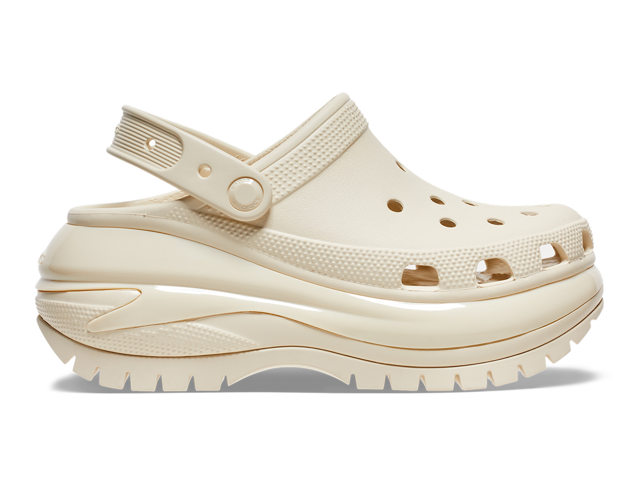 A side profile of a pair of cream platform clogs from Crocs.