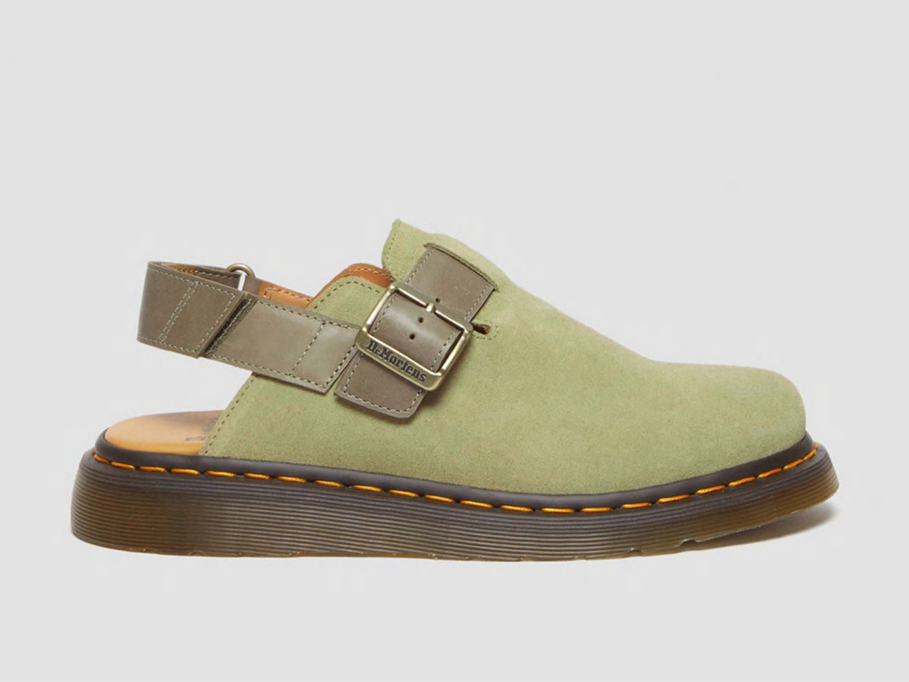 A side view of a pair of slingback green suede clogs from Dr. Martens.