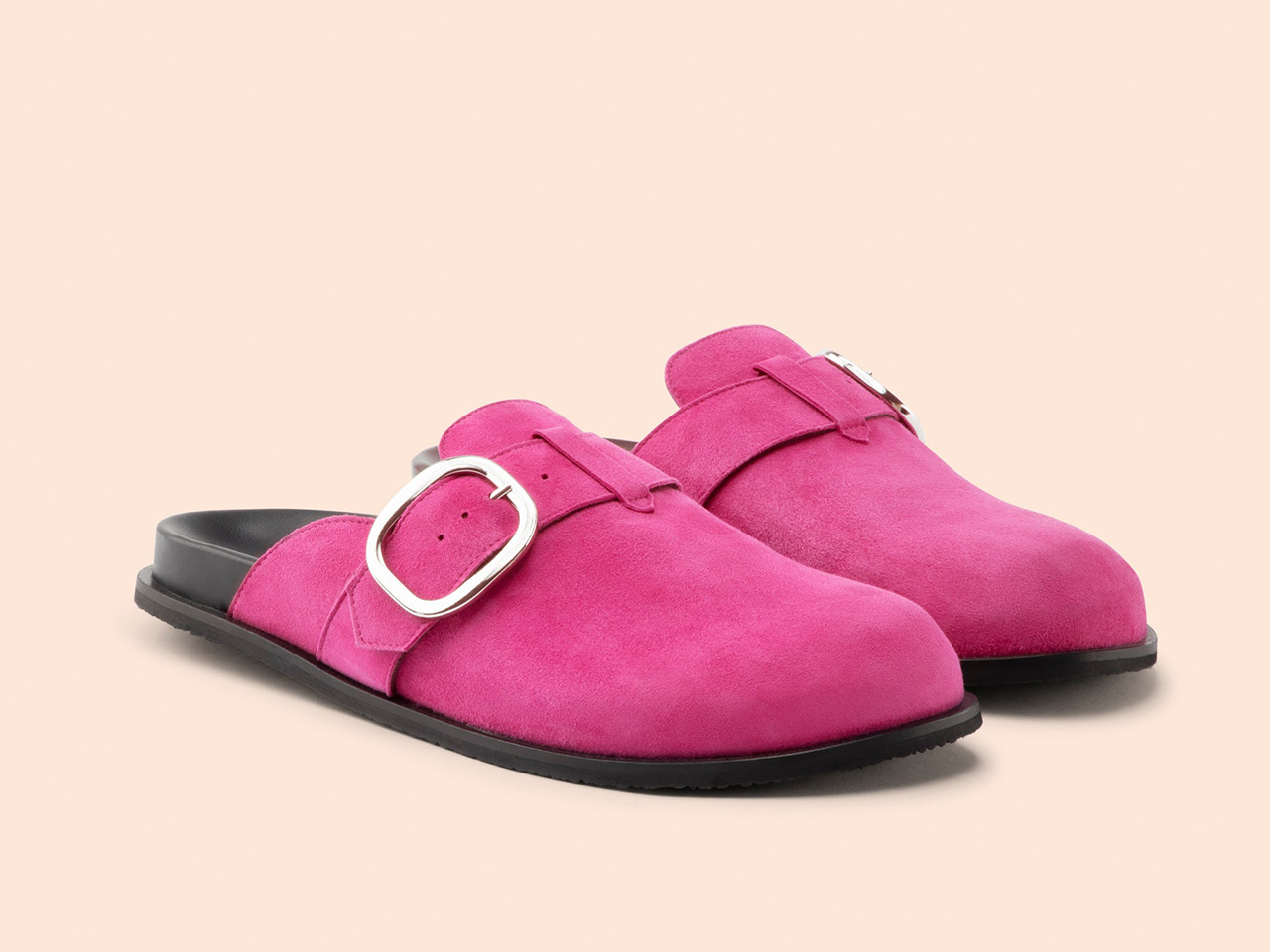 A pair of suede hot pink clogs with big silver buckles from Maguire.