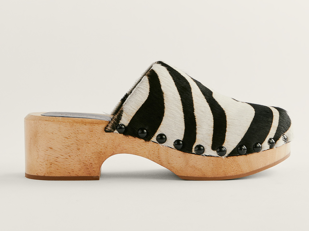 A side profile of leather and wood clogs from Reformation.