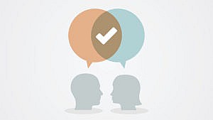 An illustration of two heads with a speech bubble indicating they are in agreement