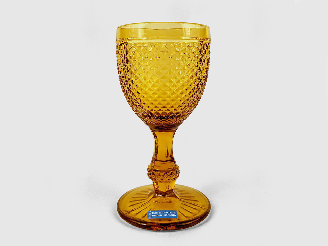 An amber glass wine glass from DMG for summer outdoor entertaining.