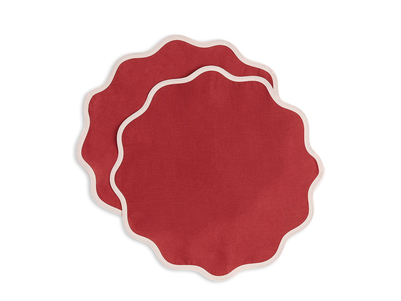 Two pink and red scalloped placemats from La DoubleJ for outdoor entertaining.