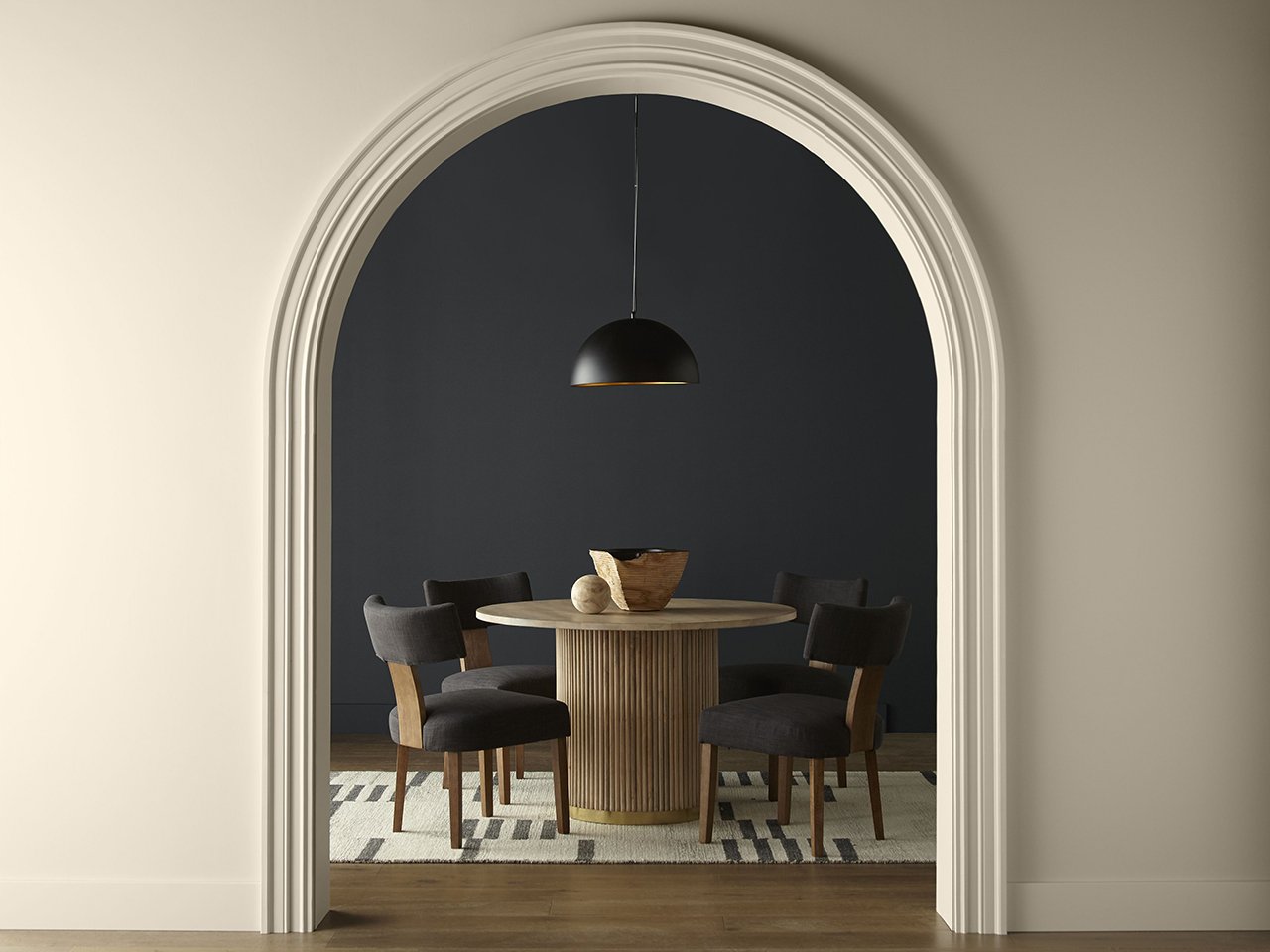 A dining room decorated with Behr 2024 Colour of the Year Cracked Pepper paint.