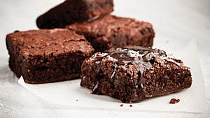 Pieces of brownies on a baking sheet.