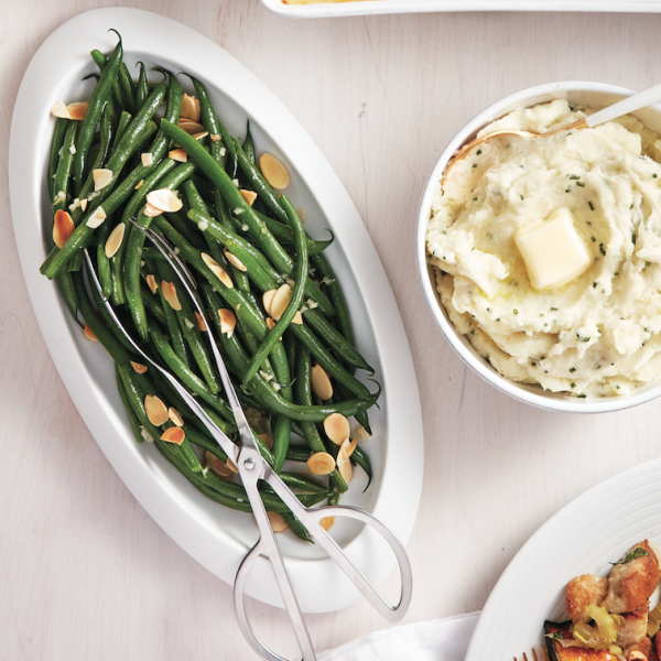 green beans topped with nuts served along with brown butter.