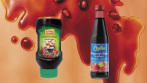 a paper background is covered in drips of fresh pomegranate molasses, with two brands of product standing in front