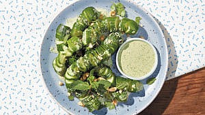 Creamy cucumber-cilantro salad served on a plate with a side of cilantro-jalapeno dressing