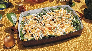 A serving tray filled with Green Bean Casserole served as part of a Thanksgiving spread