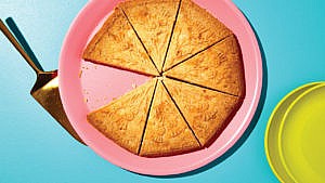 Scottish shortbread for Christmas served on a pink plate, with one wedge out of eight removed