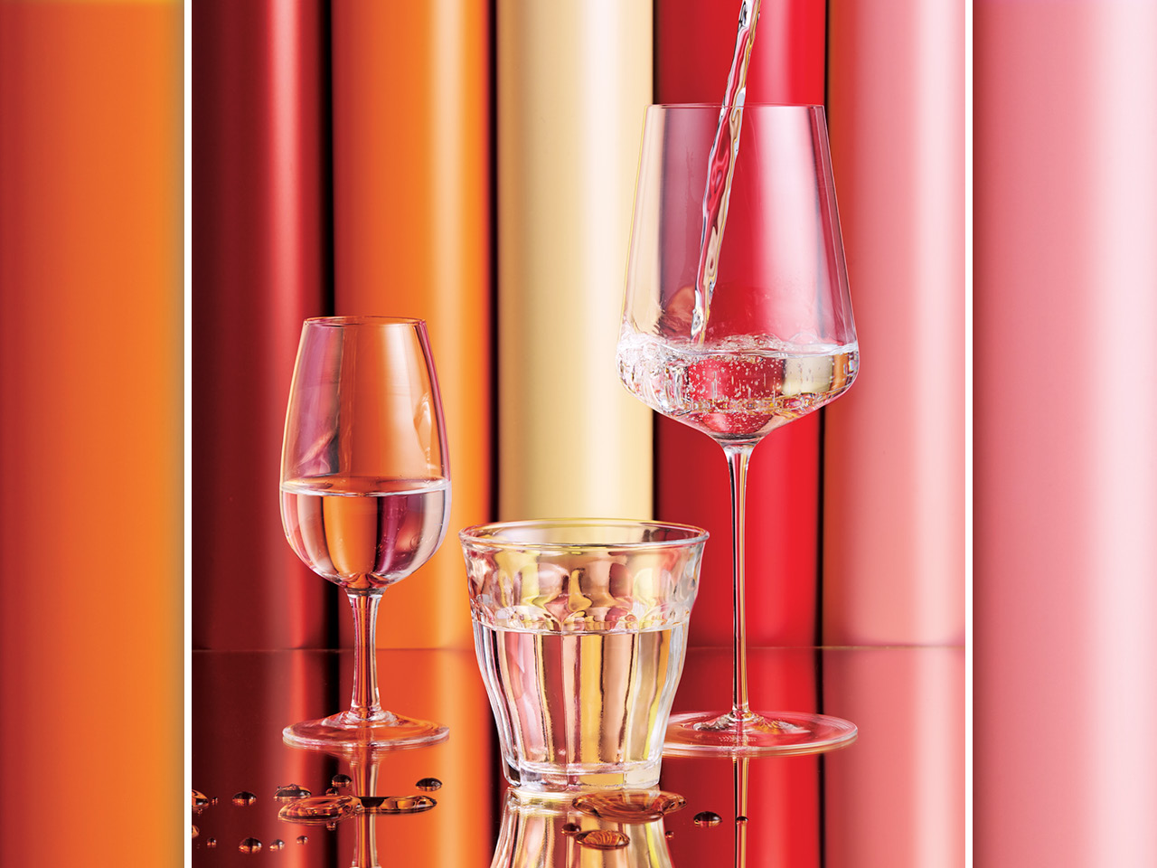 three wine glasses filled at various stages with water