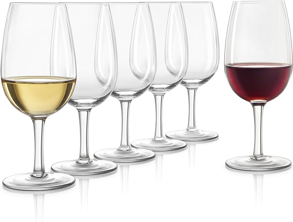 Five wine glasses with stems in a line; the leftmost is half-filled with white wine, while the rightmost is half-filled with red wine