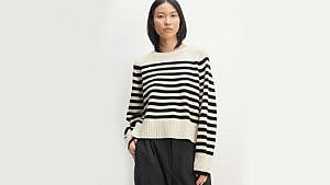 A woman wearing a striped black and white sweater, best sweaters for women