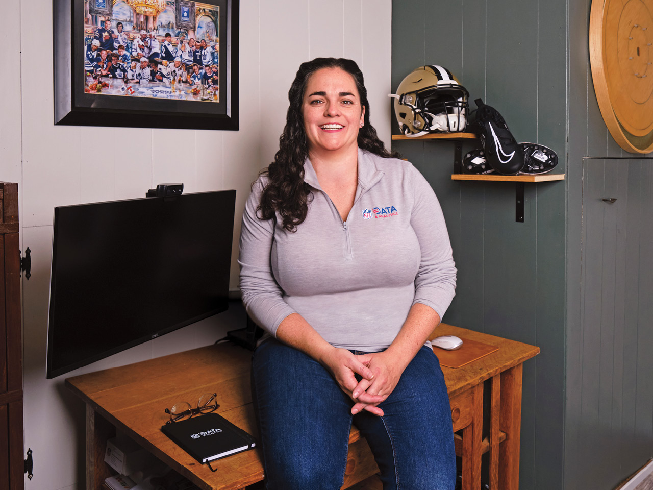 Carly Fennell sits on a desk in her home office in London, Ont.